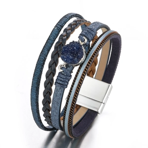 Detailed macro view of bohemian multi-layer leather bracelet with blue druzy and magnetic clasp