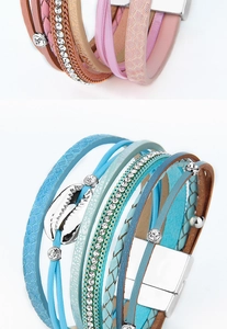 Detail of multi-layer woven bracelet with shell charms and magnetic clasp closure