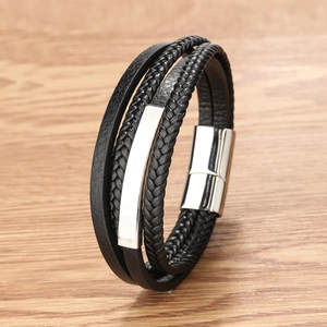 Men's multi-layer braided leather bracelet with silver magnetic steel clasp on wood