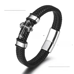 Détail d'un bracelet pour homme en cuir tressé avec croix en acier inoxydable et fermoir aimanté