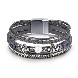 Detail of multi-layer leather bracelet with silver sea turtle charms and pearl
