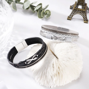 Detail view of multi-layer rhinestone leather bracelets with infinity metal charms and magnetic clasp