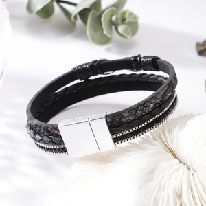 Macro detail of multi-layer black leather bracelet with crystal studs and magnetic clasp