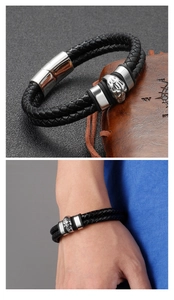 Detail of double-strand braided leather bracelet with skull charm and metal clasp