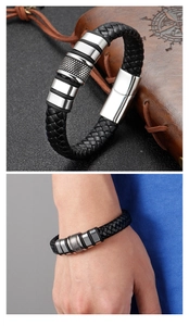 Close-up of men's braided leather bracelet with polished steel rings and metal clasp