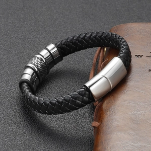 Men's hand-woven black leather bracelet with magnetic stainless steel clasp on dark surface