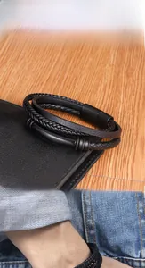 Close-up of multilayer braided leather bracelet for men with magnetic metal buckle