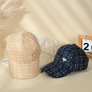 Detail of tweed baseball caps with metallic threads and heart-shaped rhinestone accents