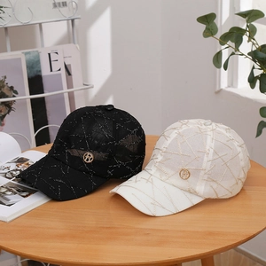 Fashionable baseball cap with embroidered lines and R metal badge in black and white colors