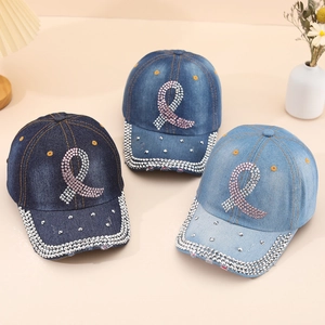 Three denim baseball caps in shades of blue with pink rhinestone ribbon motifs