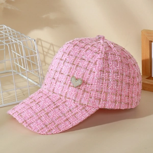 Detail of pink tweed baseball cap with gold metallic thread and heart sequin patch