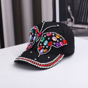 Detail of colorful rhinestone butterfly and dual-row crystal trim on black baseball cap