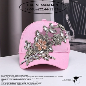 Détail d'une casquette rose faite main avec broderie florale 3D et strass brillants
