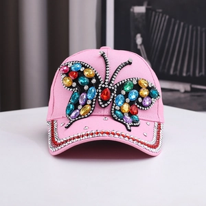 Close-up of pink denim baseball cap with colorful rhinestone butterfly design details