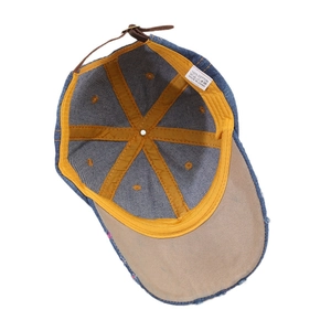 Deep blue denim baseball cap featuring inner yellow tape and adjustable leather strap