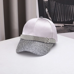 Detailed macro view of satin baseball cap with sequined brim and rhinestone buckle strap