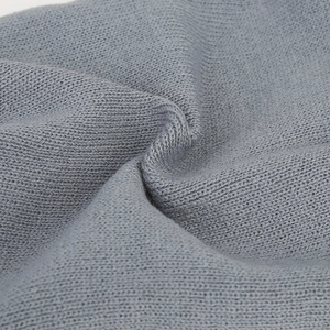 Macro detail of high-quality dark grey knitted fabric showing soft wool texture and weave