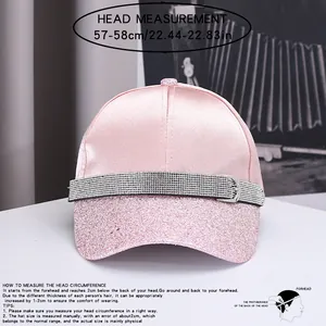 Close-up detail showing pink satin baseball cap head measurement and size guide info