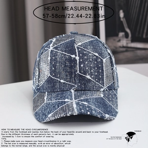 Detail of blue denim baseball cap with silver sequins and distressed frayed edges