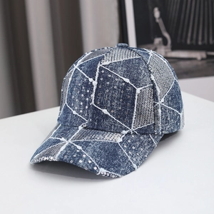 Detail of blue denim baseball cap featuring silver sequins and geometric patchwork design