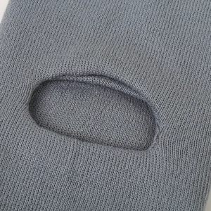 Close-up of fine-knit grey winter hat showing smooth texture and precision oval opening