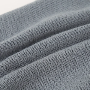 Close-up of the grey knitted wool fabric texture on this infant winter earflap hat