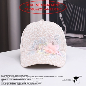 Close-up of lace baseball cap with floral embroidery, 3D chiffon flowers and pearl accents