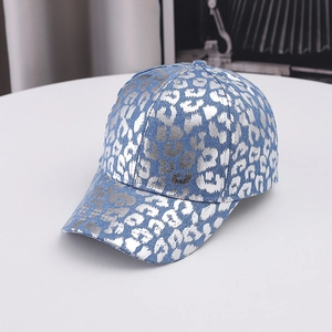 Detailed view of silver metallic leopard print on a classic denim blue baseball cap