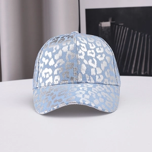 Detail of light blue baseball cap with silver metallic leopard print in a trendy style