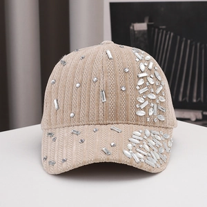 Close-up detail of luxury beige velvet baseball cap with sparkling crystal rhinestones