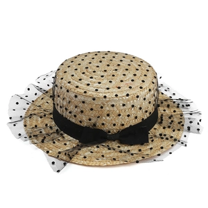 Elegant wide brim straw hat with black polka dot mesh veil and decorative ribbon bow