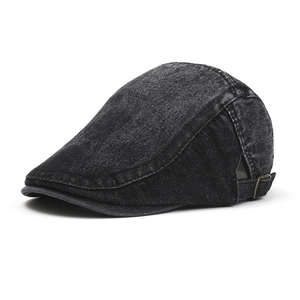 Close-up of vintage dark grey washed denim newsboy cap with adjustable metal side buckle
