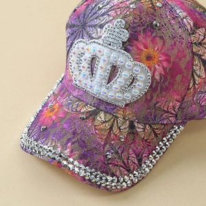Detail of purple floral baseball cap with rhinestone brim and pearl crown patch