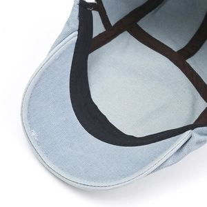 Detail view of the inner lining and sweatband construction of this light blue denim beret