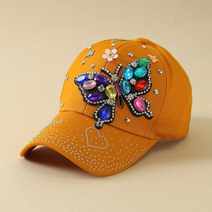 Detail of colorful rhinestone butterfly design on orange baseball cap for women