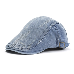 Vintage light blue denim newsboy cap with distressed details and adjustable side buckle