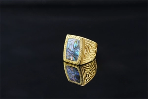Macro detail of vintage men's signet ring with rectangular abalone shell inlay