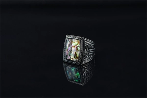 Macro shot of rectangular abalone shell inlay on a vintage black silver signet ring