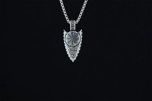 Detail of Viking arrow pendant with Vegvisir symbol and Valknut engraving on silver chain