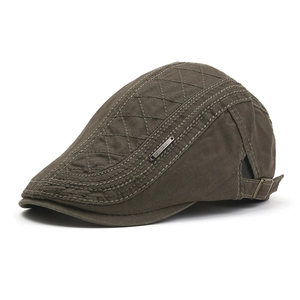 Detailed side view of vintage cotton flat cap featuring diamond quilted stitching and metal buckle