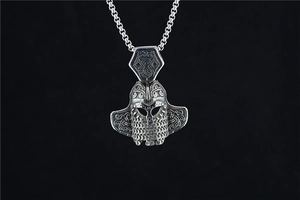 Macro view of vintage silver Viking pendant with Nordic knots and warrior helmet details