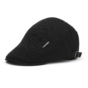 Detail view of cotton flat cap with diamond quilted side and metal adjustment buckle