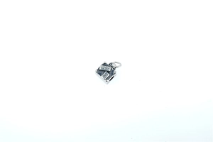 Macro detail of a silver mini suitcase pendant featuring vintage PARIS engraving