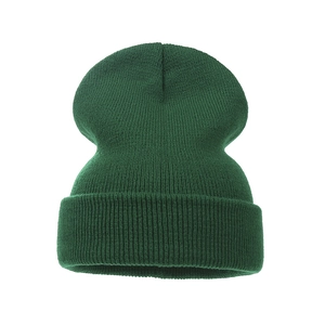 Close-up of forest green knitted beanie featuring a thick ribbed texture and folded cuff