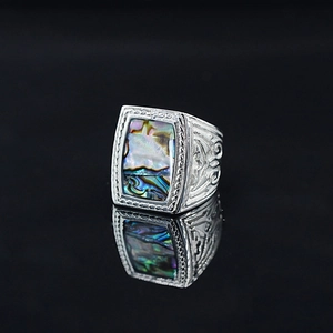 Vintage silver signet ring for men featuring a rectangular abalone shell inlay with floral engraving