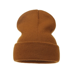Detailed close-up of caramel knit beanie showing thick ribbed texture and folded cuff design