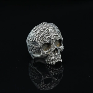 Vintage oxidized silver skull ring with ornate floral carvings and gothic details