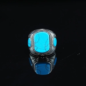 Retro turquoise ring with rectangular center stone and silver braided metal details