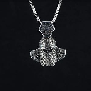Vintage silver Viking helmet pendant with Celtic knotwork on a black background