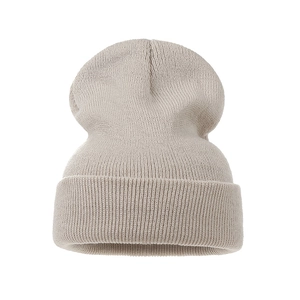 Close-up of oatmeal knit beanie showing ribbed texture and folded cuff design